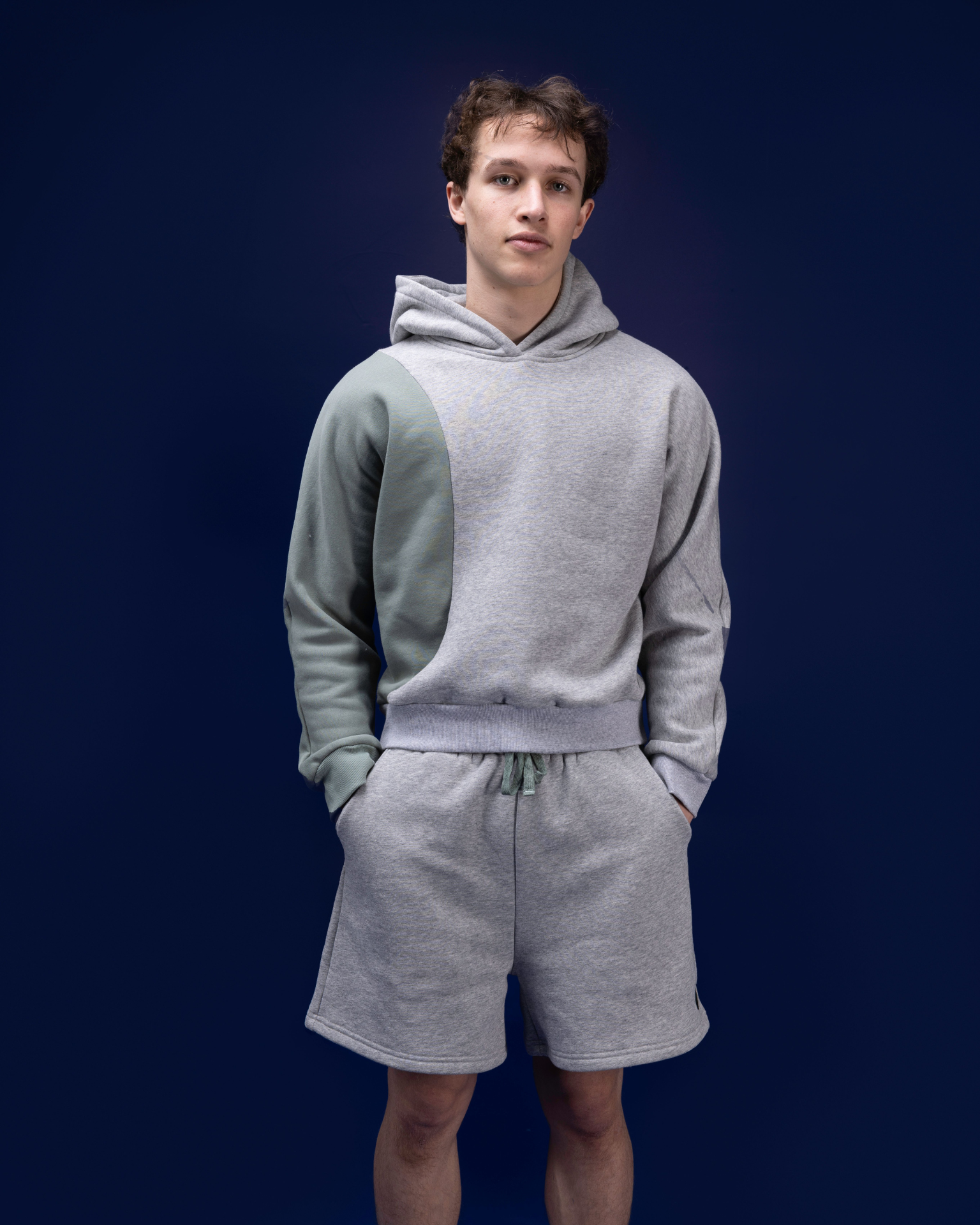 Male dancer wearing male dancewear grey warm up shorts