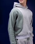 Male dancer wearing male dancewear grey and green warm up shorts