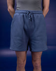 Male dancer wearing male dancewear blue warm up shorts