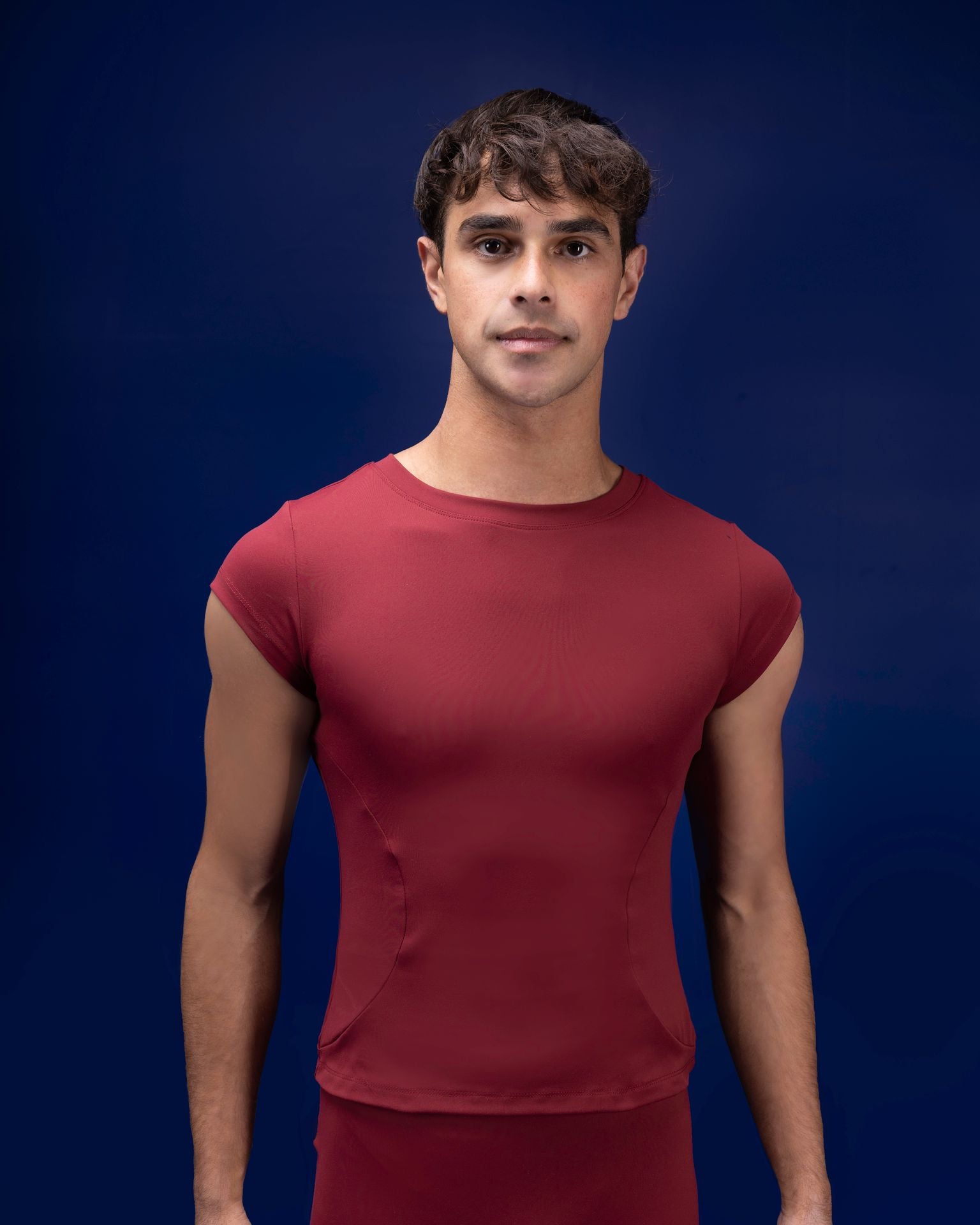 Male dancer wearing male dancewear red tee